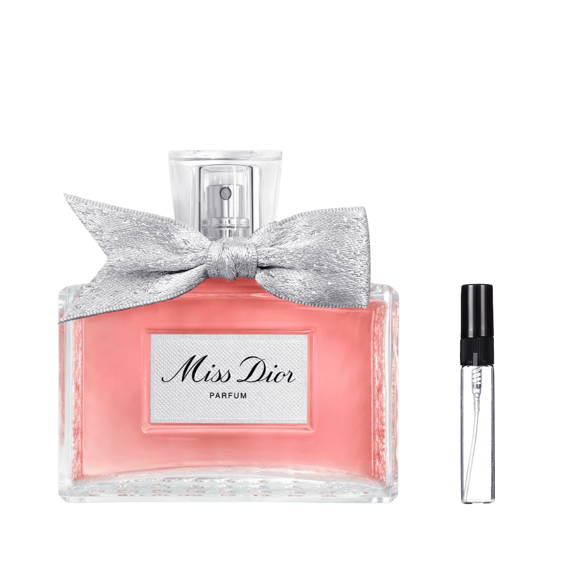 Różowy flakon Miss Dior Parfum ze srebrną kokardą obok szklanej fiolki odlewki perfum – ODVARO.